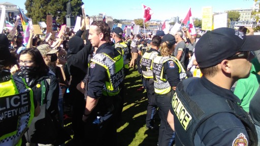 Captured in September 2023 at a counterprotest to the 1 Million March For Children at the Legislative Assembly of British Columbia in Victoria, between two rows of cops separating the factions.