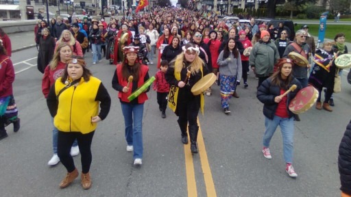 Hundreds of Stolen Sisters Memorial March participants walk toward the Legislative Assembly of British Columbia in Victoria.